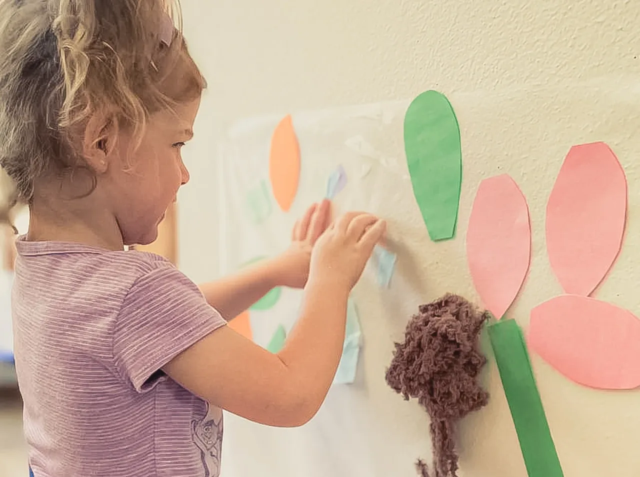 Child making a flower craft