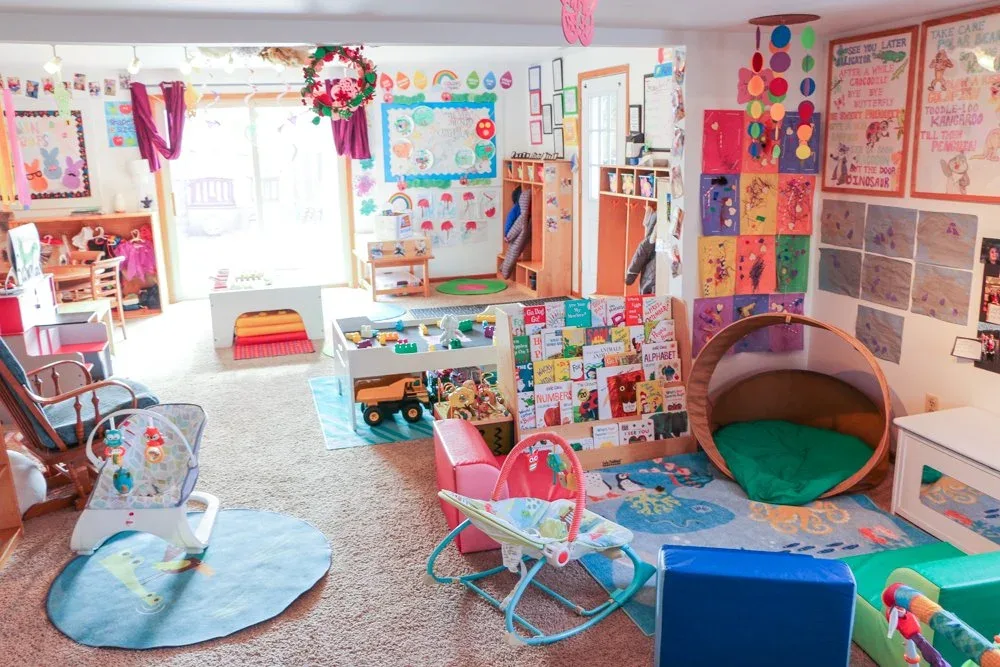 Morraine View playroom with colorful rugs, toys, and a play tunnel at BBDS Morraine View, Madison, WI