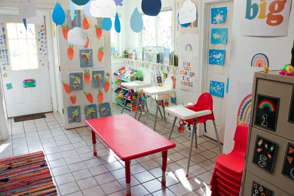 Bright eating area with high chairs and displayed artwork