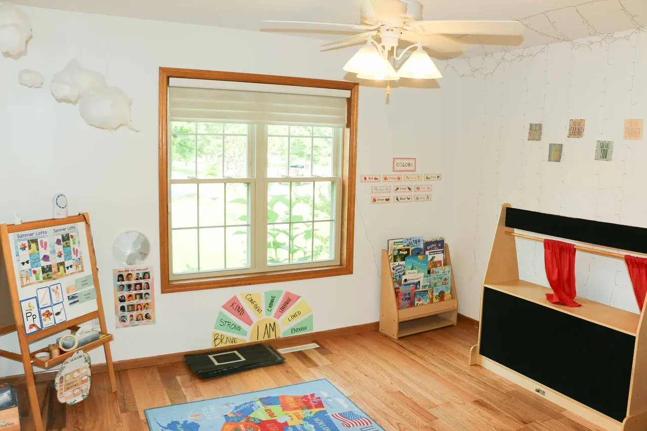 Castle Pines reading area with bookshelves beneath a window at BBDS Castle Pines, Madison, WI