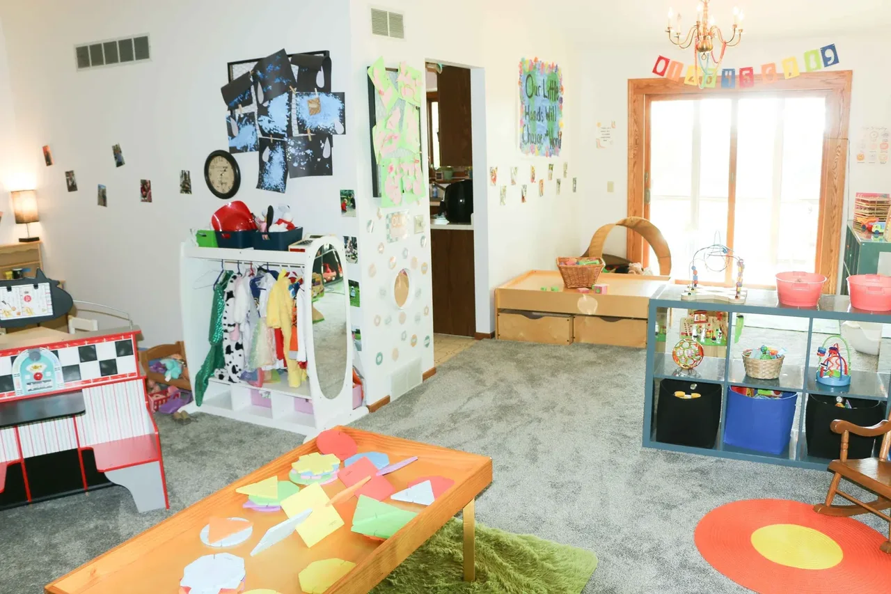 Valley Woods classroom with activity tables, toys, and a bright window