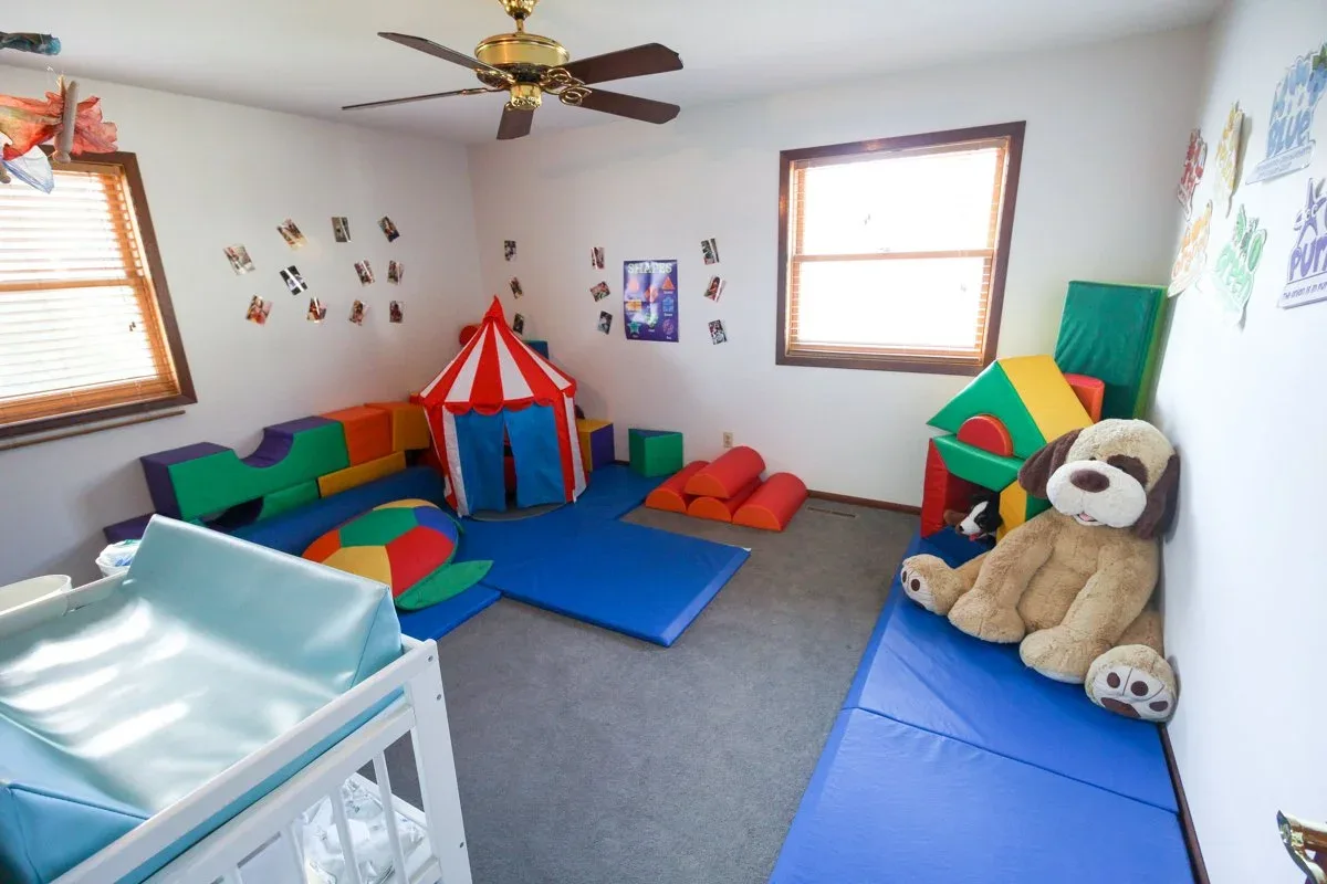 Kempfer Lane playroom with a small tent, stuffed toys, and floor mats at BBDS Kempfer Lane, Verona, WI