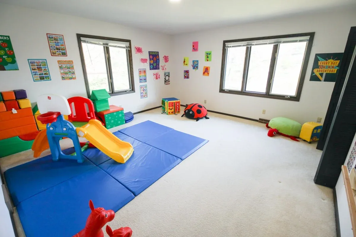 Applewood activity room with a yellow slide on a blue floor mat at BBDS Applewood Drive, Madison, WI