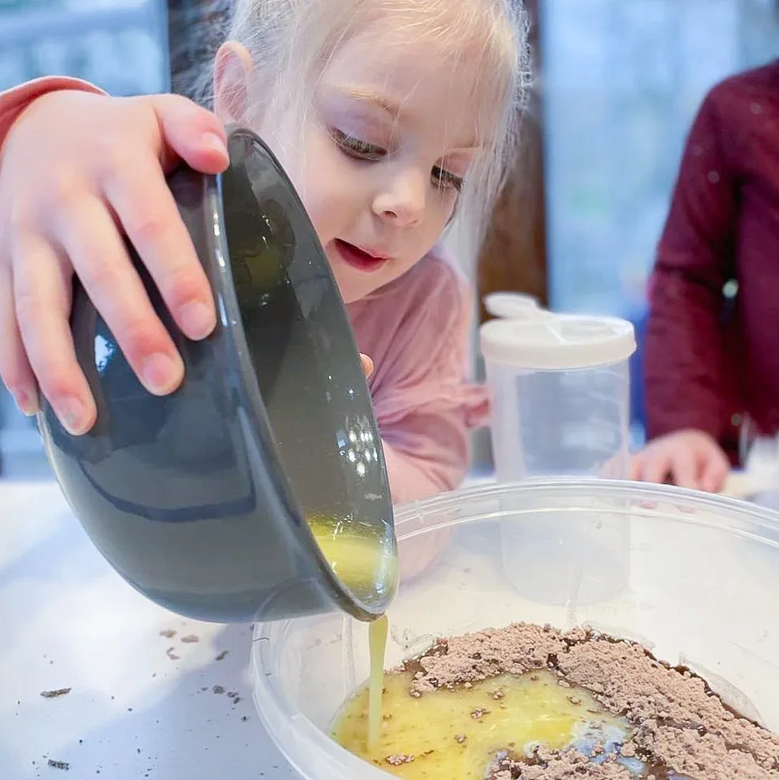 Child mixing ingredients in a bowl