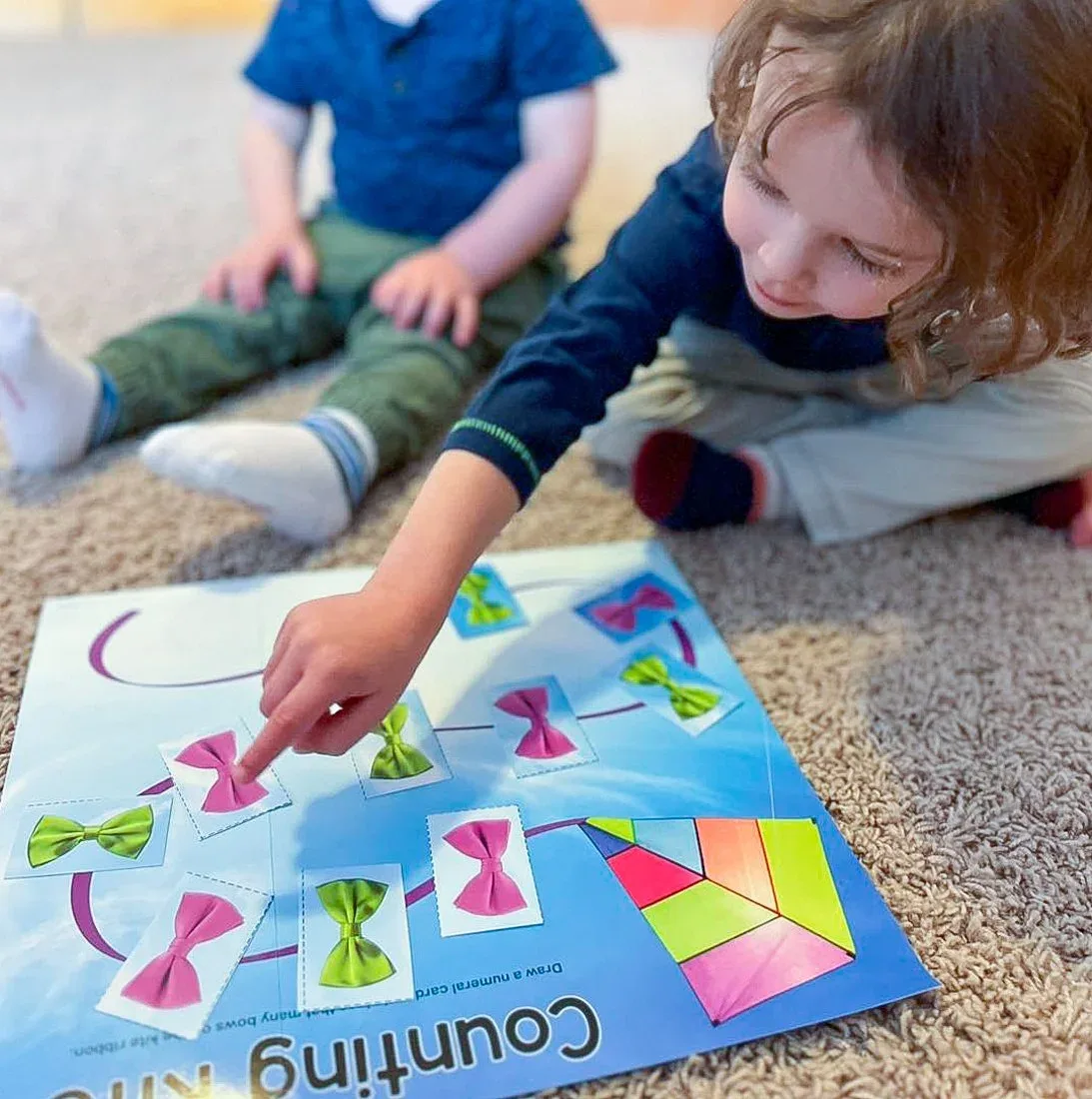 Child working on a counting activity with colorful picture cards