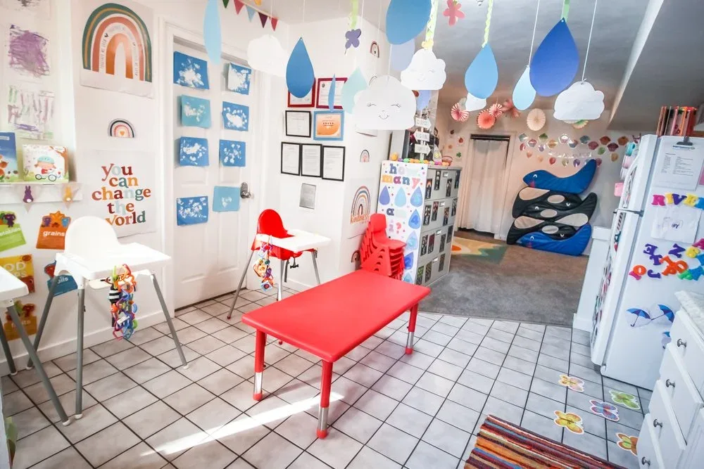 Bright room with high chairs and a red child-sized table