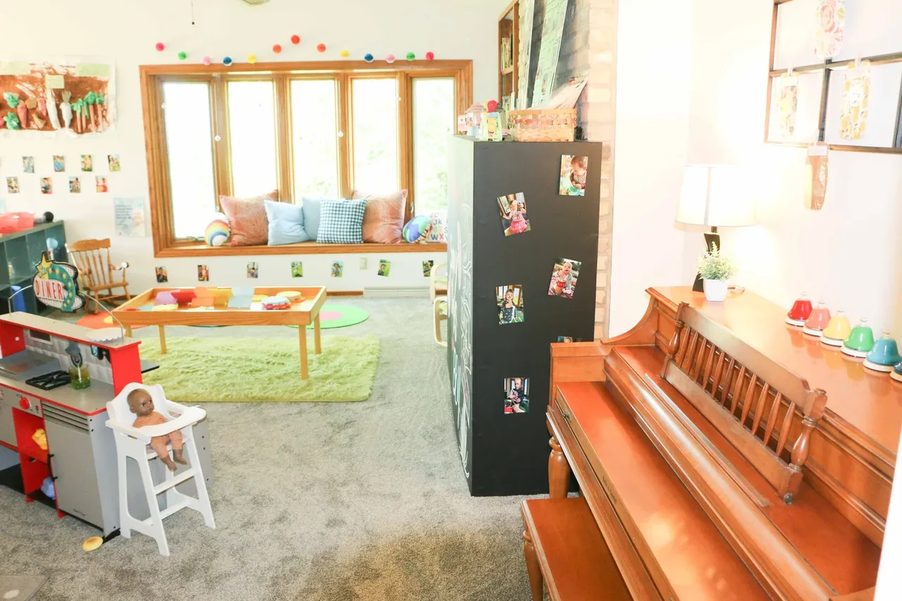 Valley Woods classroom with an upright piano and low activity tables at BBDS Valley Woods, Verona, WI