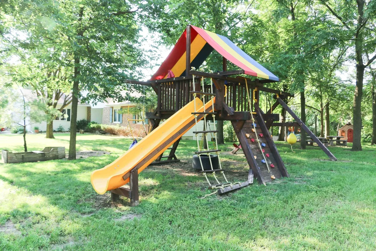 Valley Woods outdoor play structure with a yellow slide at BBDS Valley Woods, Verona, WI