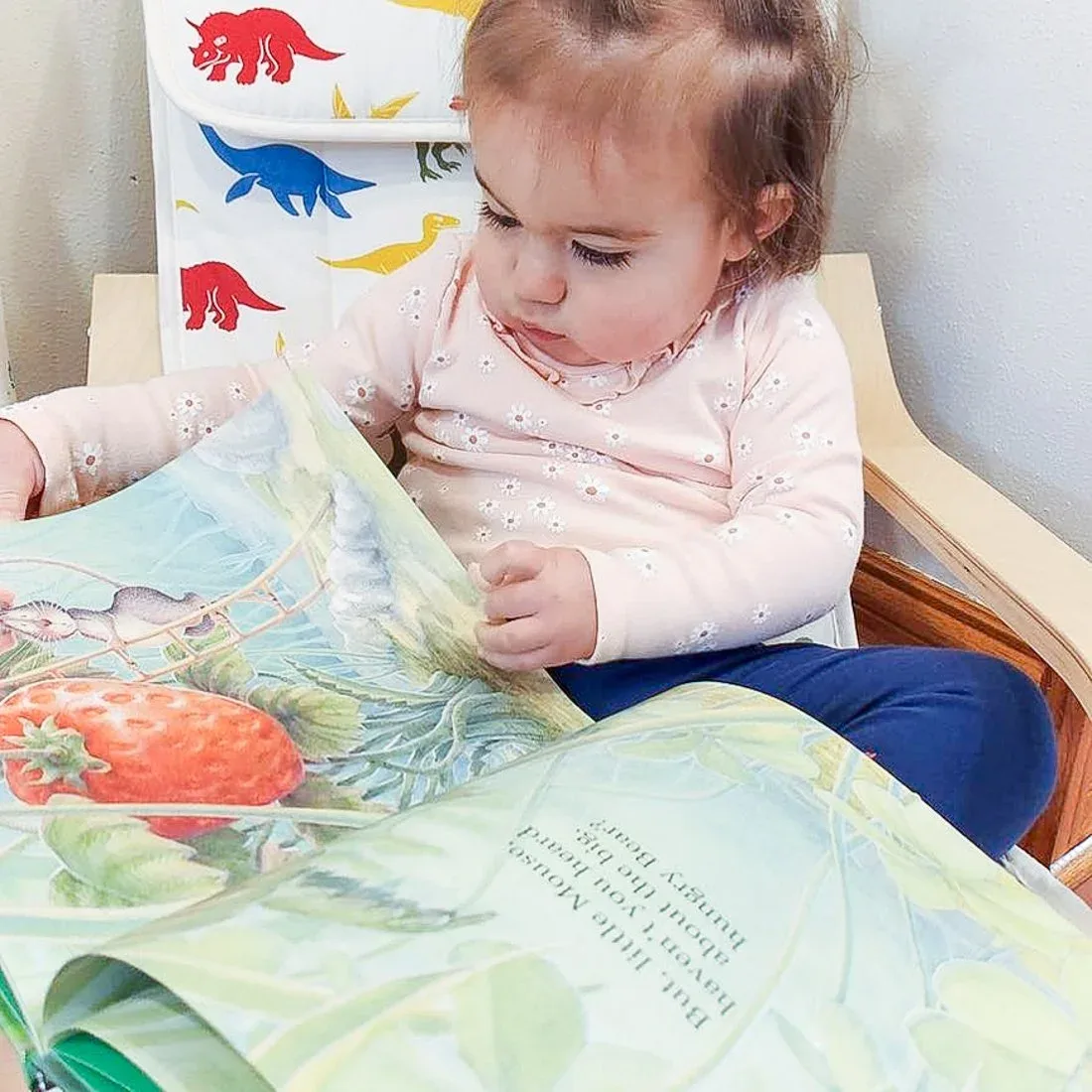 A child looking through an open picture book
