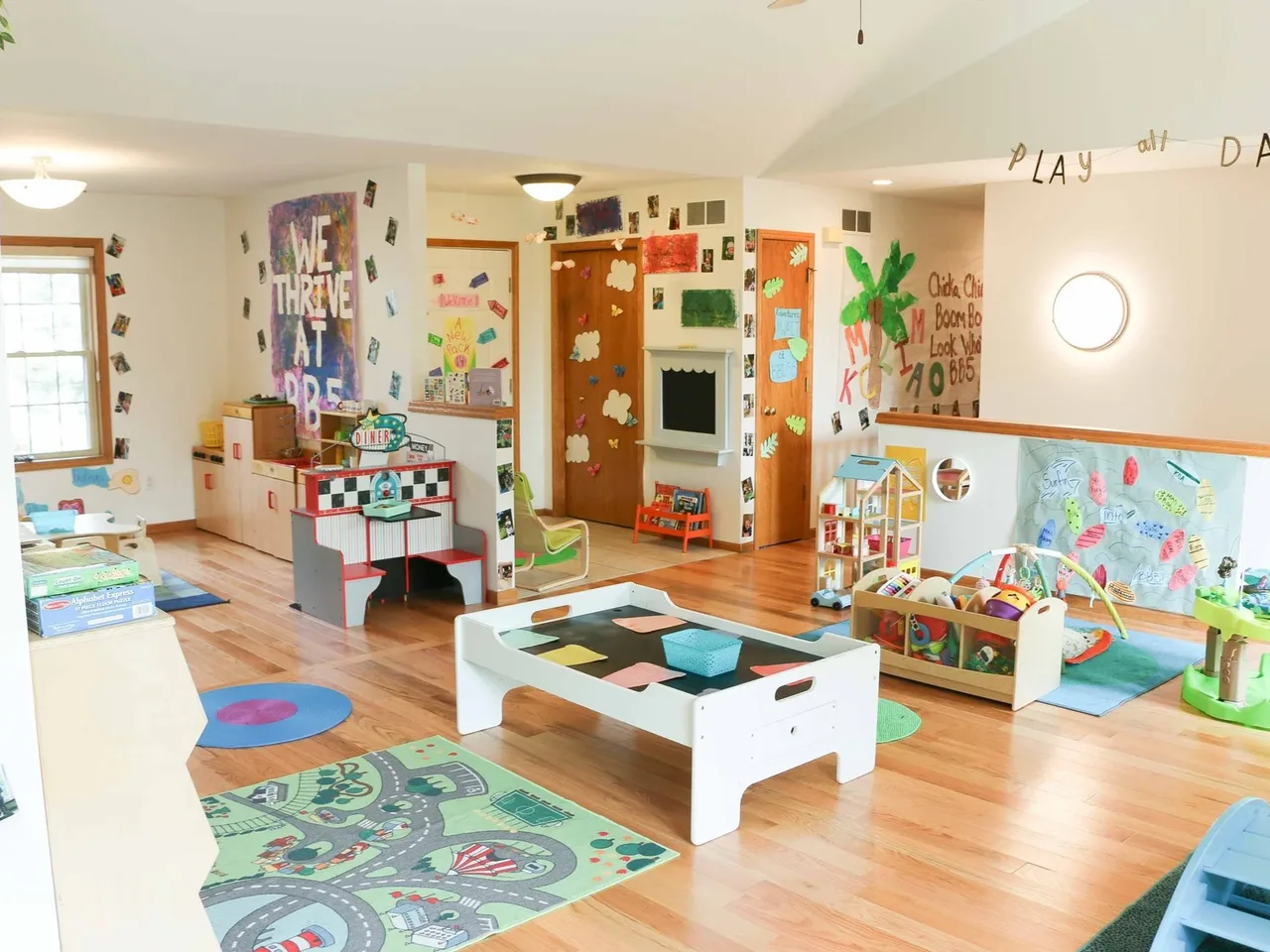 Castle Pines classroom with a low activity table, toys, and wall displays