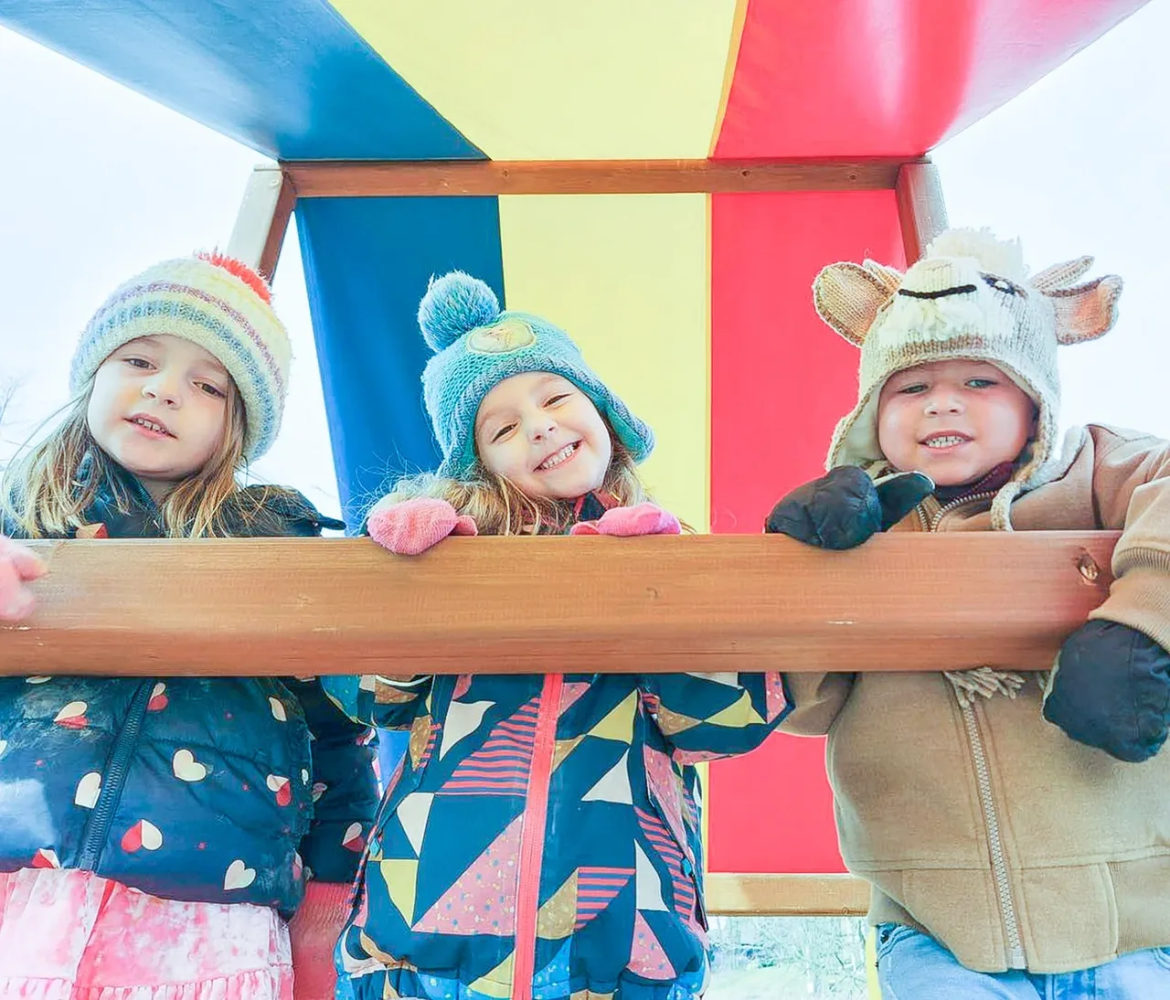 Children playing on colorful climbing equipment