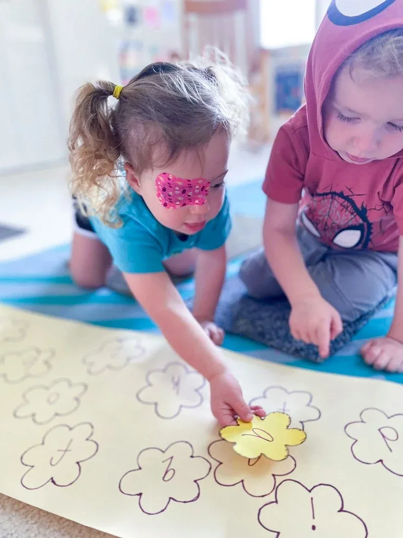 Children working together to match letter shapes