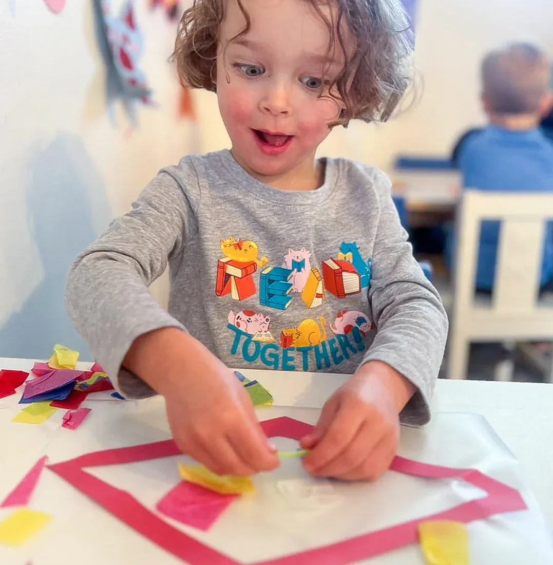 Child making a colorful craft