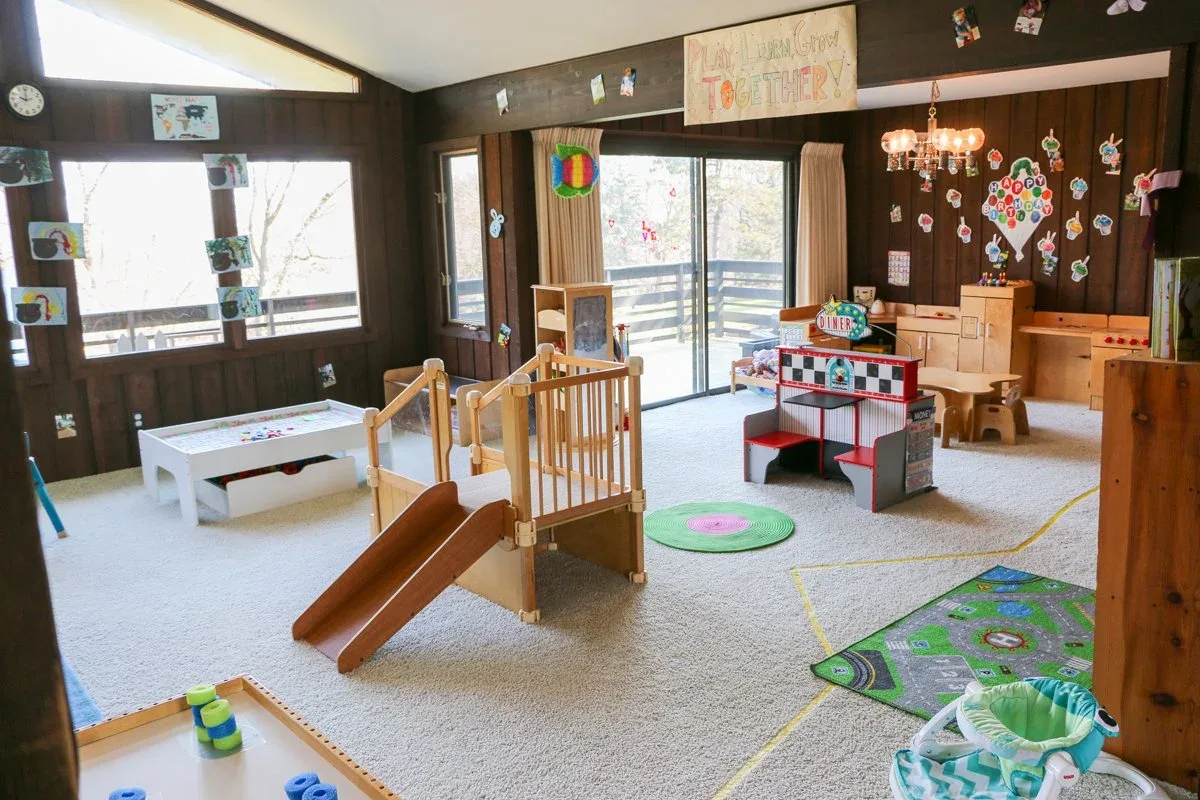 Applewood playroom with a wooden slide and activity table at BBDS Applewood Drive, Madison, WI