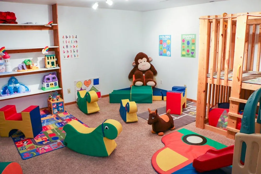 Morraine View play corner with low seating, toys, and floor mats at BBDS Morraine View, Madison, WI