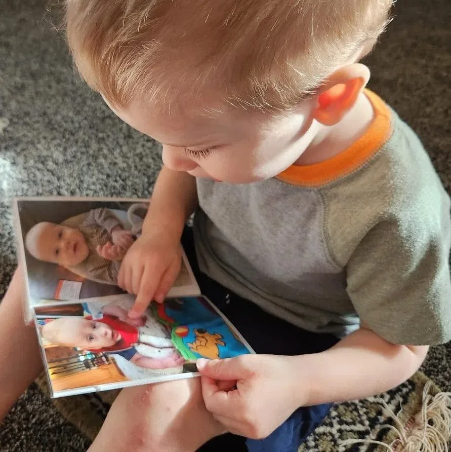 Child looking through family photographs