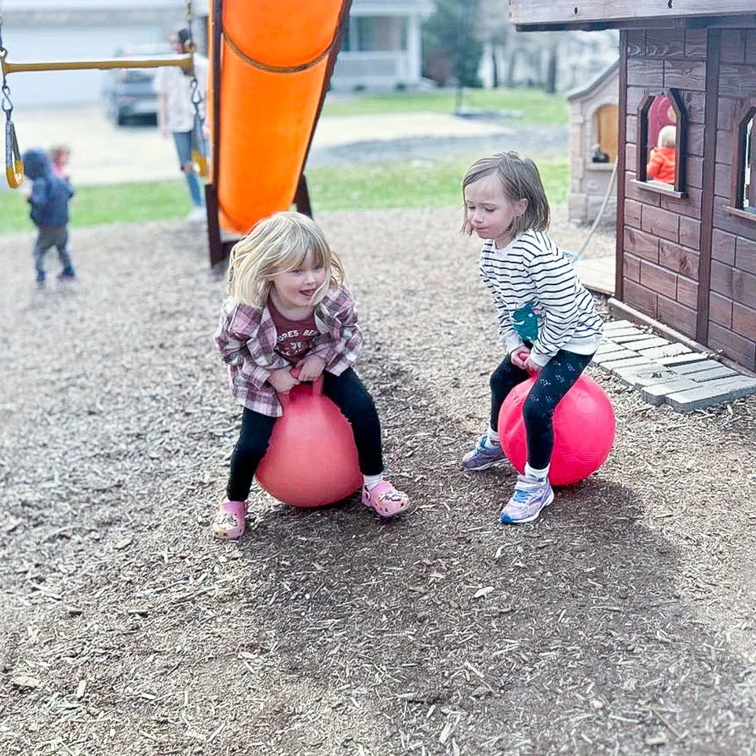 Children playing on bouncy balls